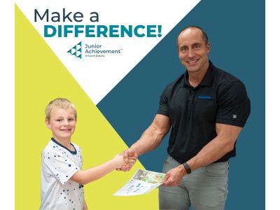 JA volunteer with student, text says Make a Difference